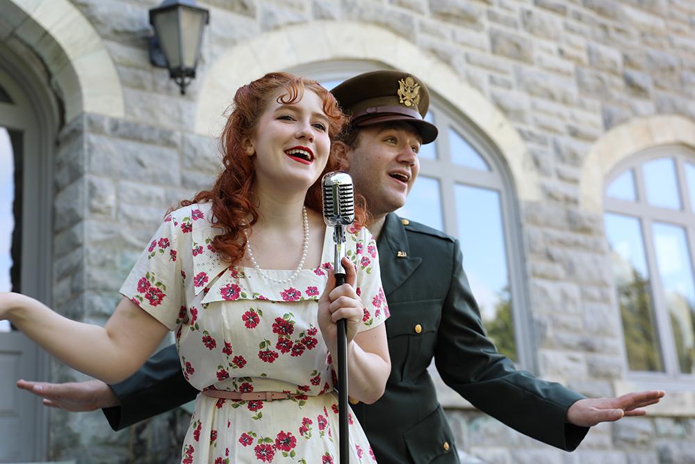 Performers dressed in 50's costumes in front of the castle